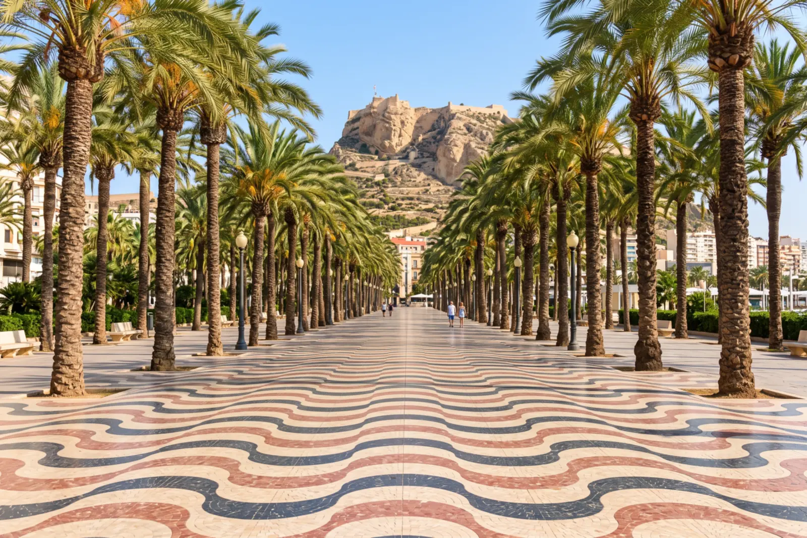 Alicante's Explanada de España, with its wave-patterned mosaic paving and palm trees, and Santa Bárbara Castle in the background